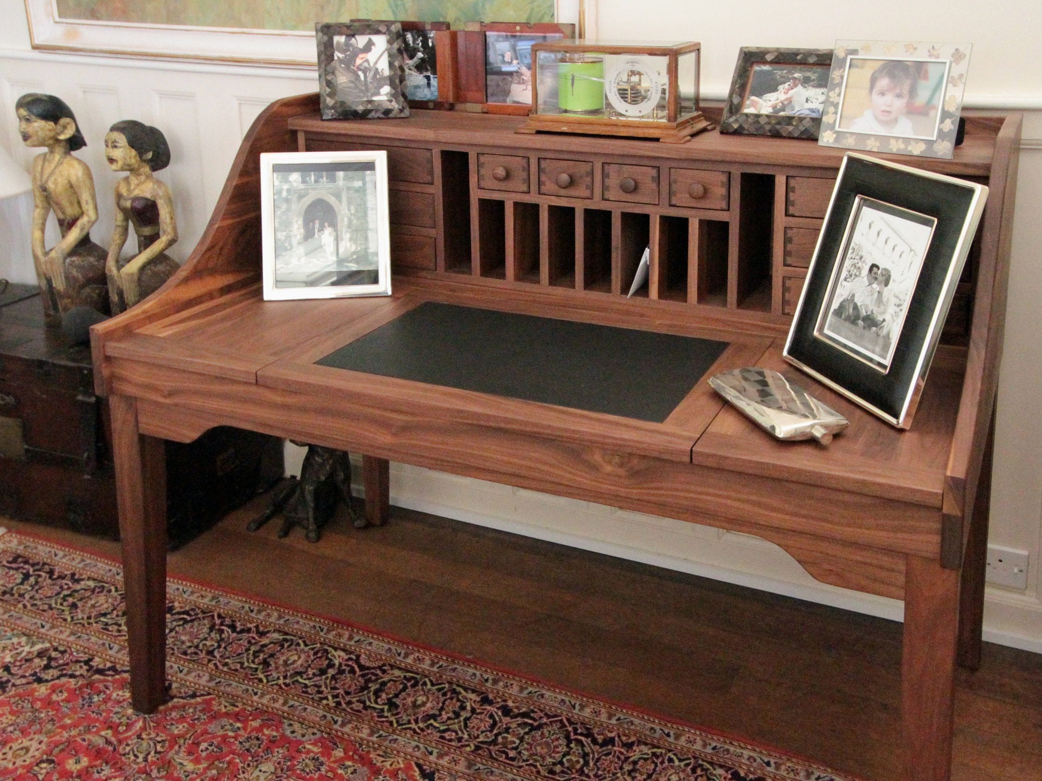 Walnut writing desk with pigeonholes, small drawers and leather inlaid top