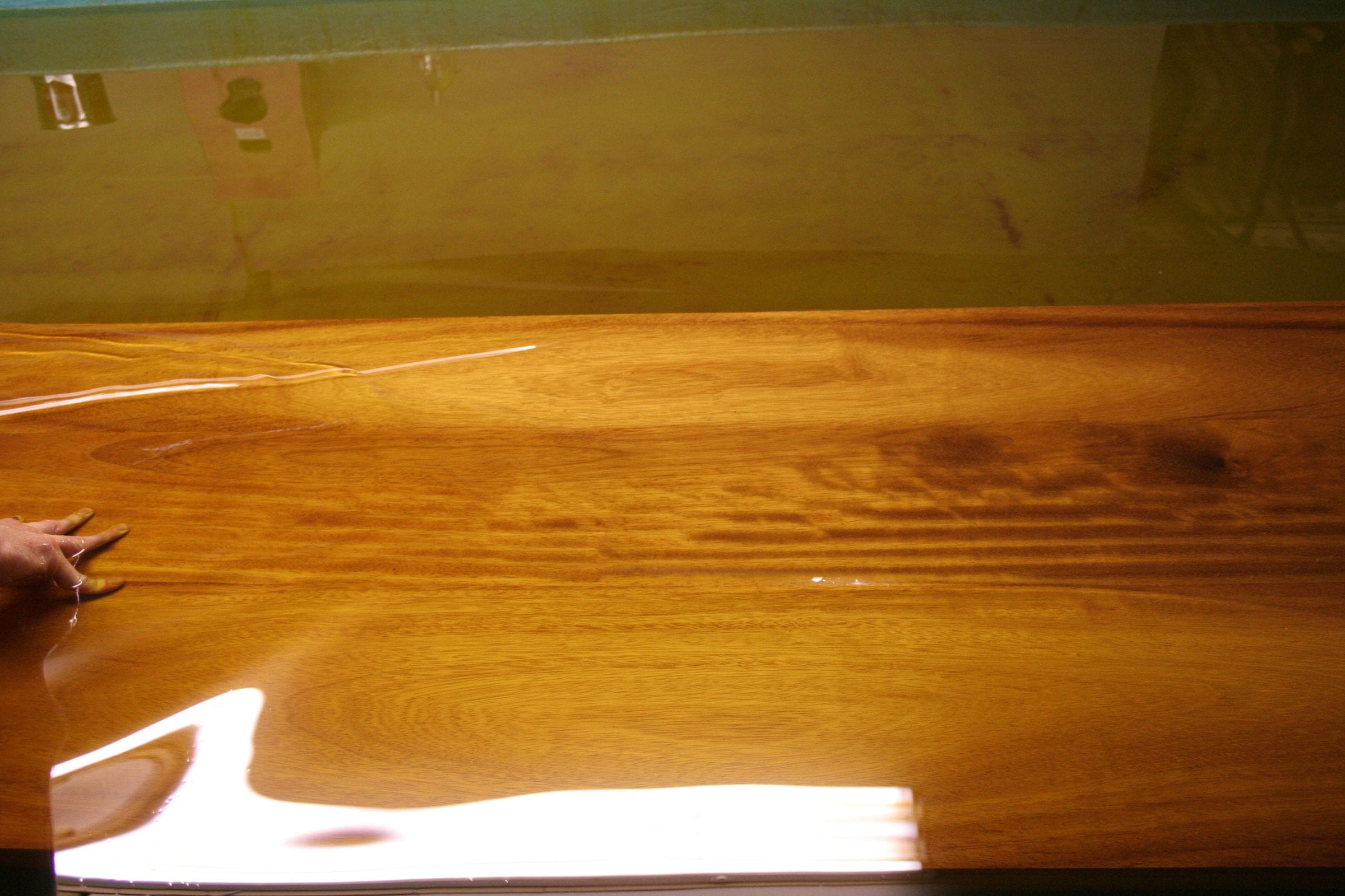 Close-up of a freshly oiled iroko worktop with glossy golden grain