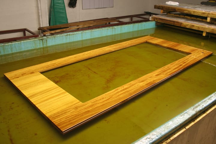 Freshly oiled iroko worktop with cutout drying over the workshop dip tank