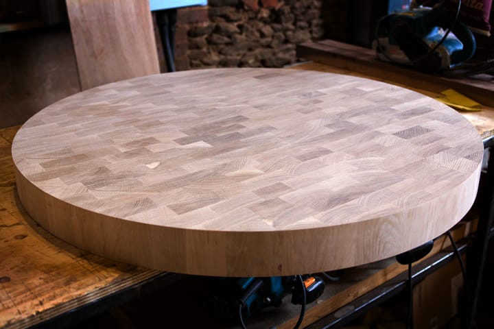 Circular end grain oak butcher's block top on the workshop bench