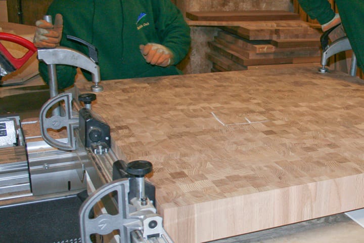 Craftsman machining a clamped end grain oak block in the workshop