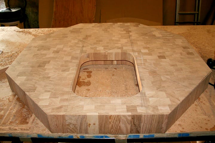 Octagonal end grain oak block with routed cut-out during workshop fabrication