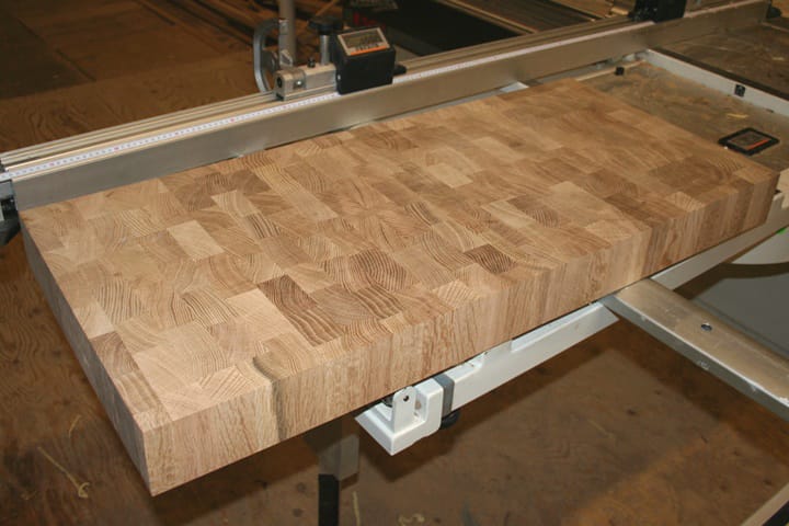 Thick end grain oak butcher's block on the sliding table saw