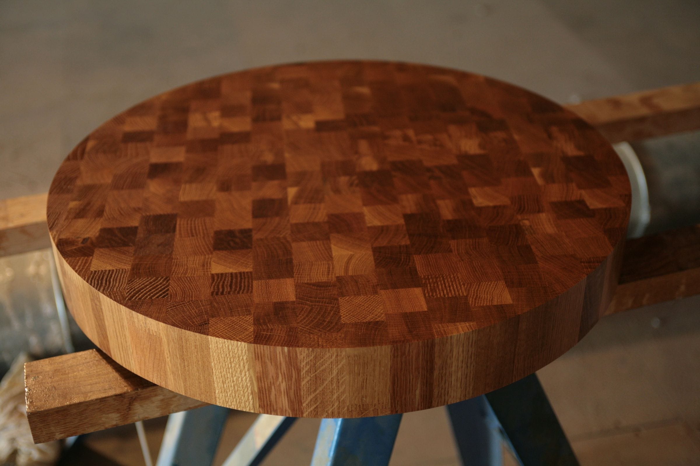 Round end grain oak chopping block top on workshop trestles