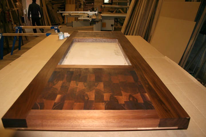 Walnut worktop with end grain chequerboard panel and cutout on the workshop bench