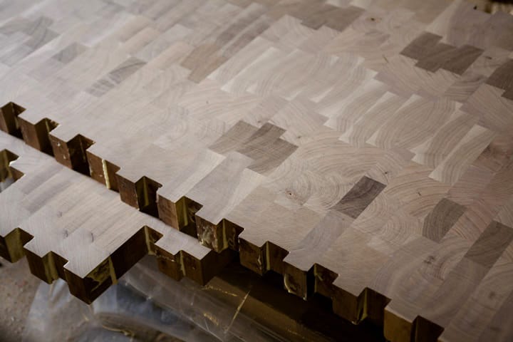 Unfinished walnut end grain sections with glued finger joints before sanding