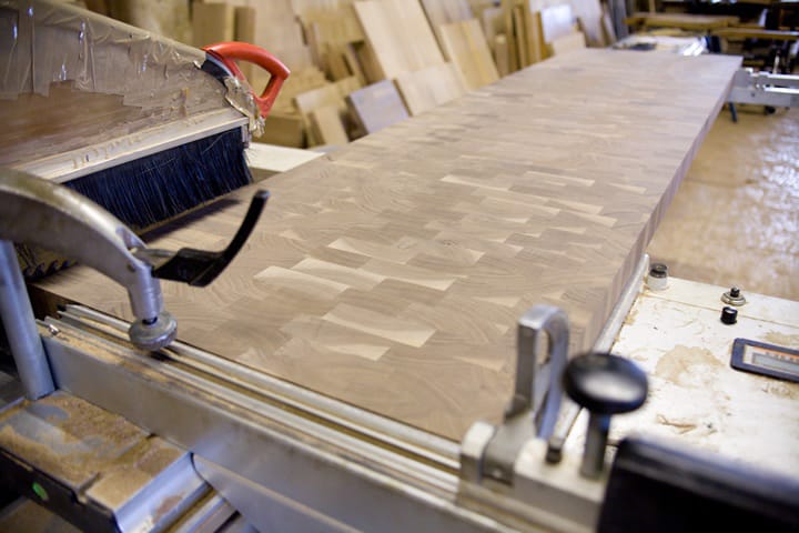 Long walnut end grain worktop clamped on the saw bench in the workshop