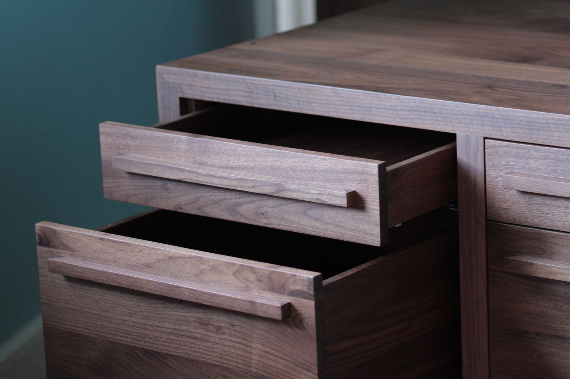Walnut chest with two drawers pulled open, showing long solid wood handles
