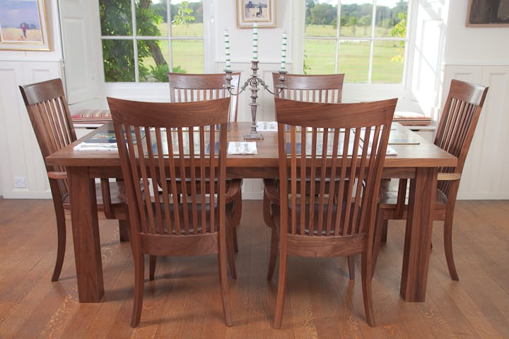 Six-seat walnut dining set with silver candelabra in a bright period dining room