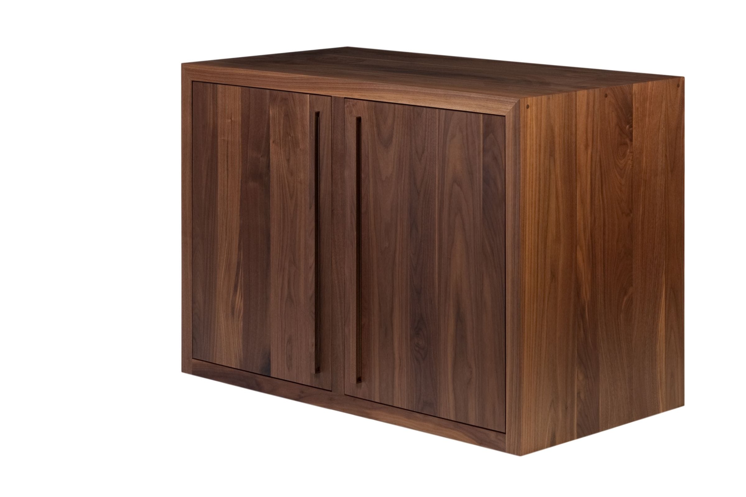 Angled view of a two-door solid walnut cabinet with slim vertical handles