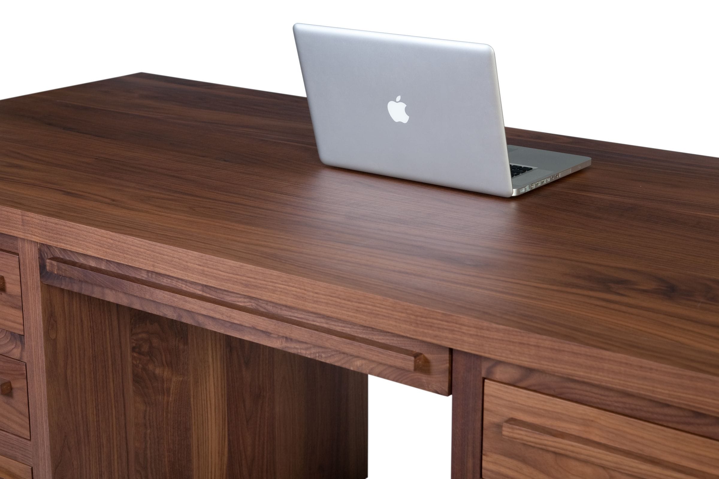 Laptop on the figured top of a solid walnut pedestal desk