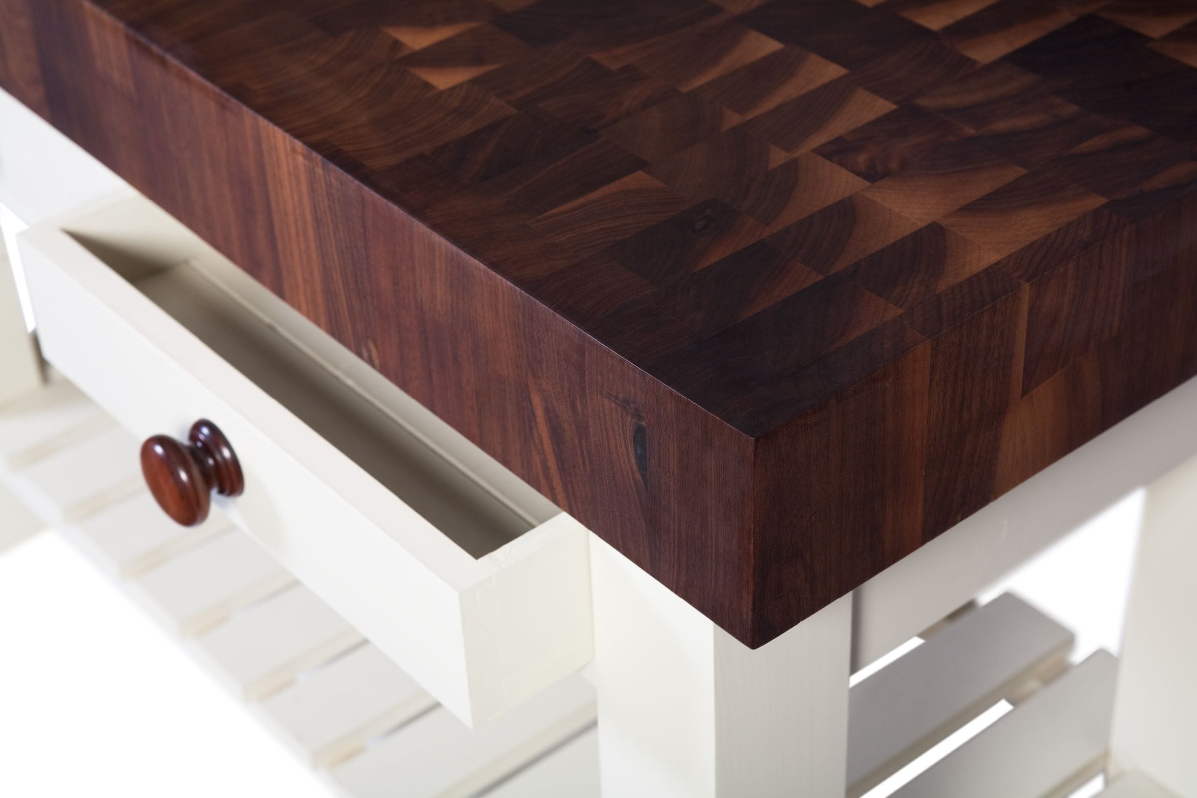 Close-up of chequered end-grain walnut butcher's block top on a cream base