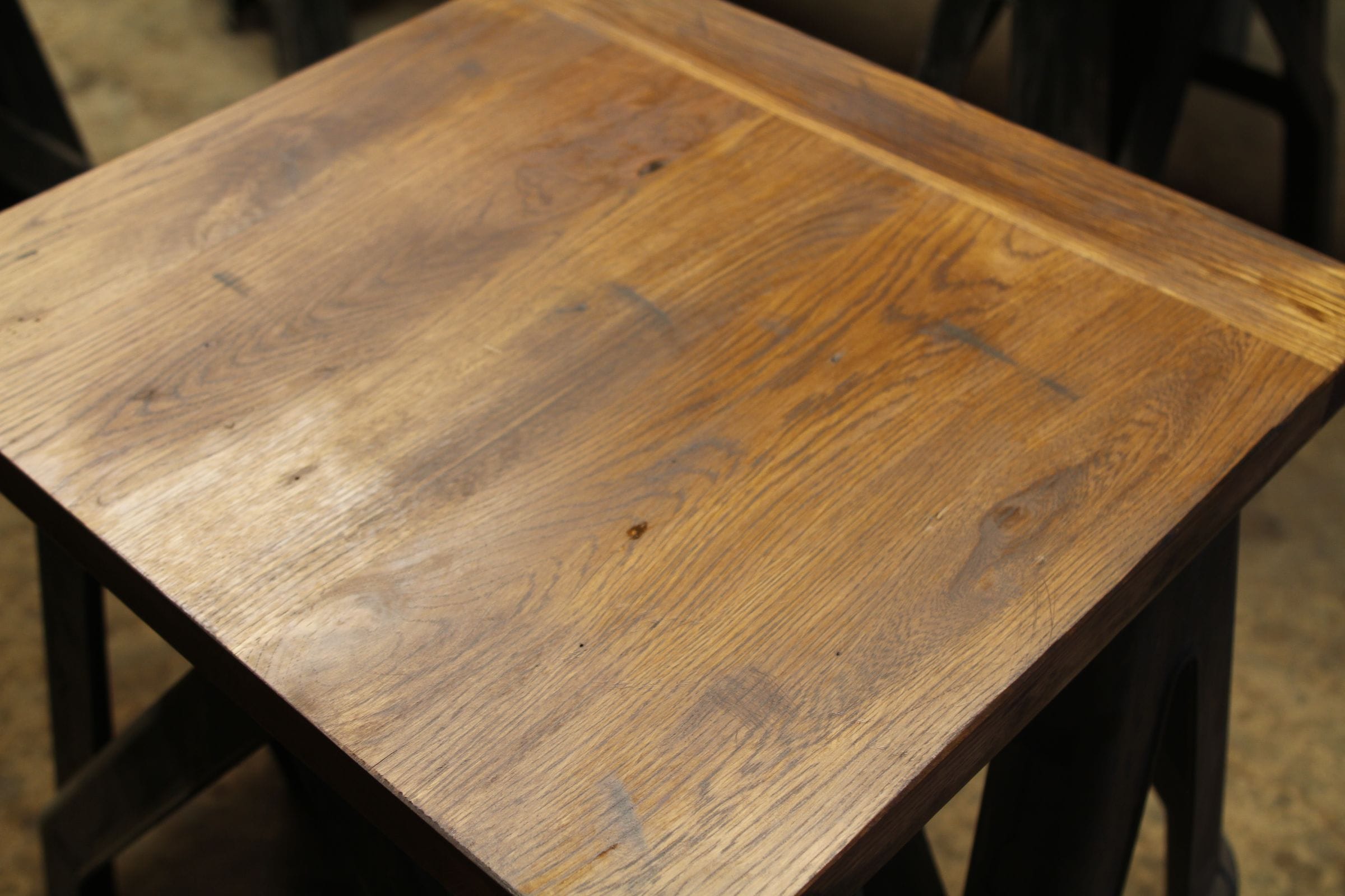 Freshly finished oak worktop showing knots and grain on a workshop stand
