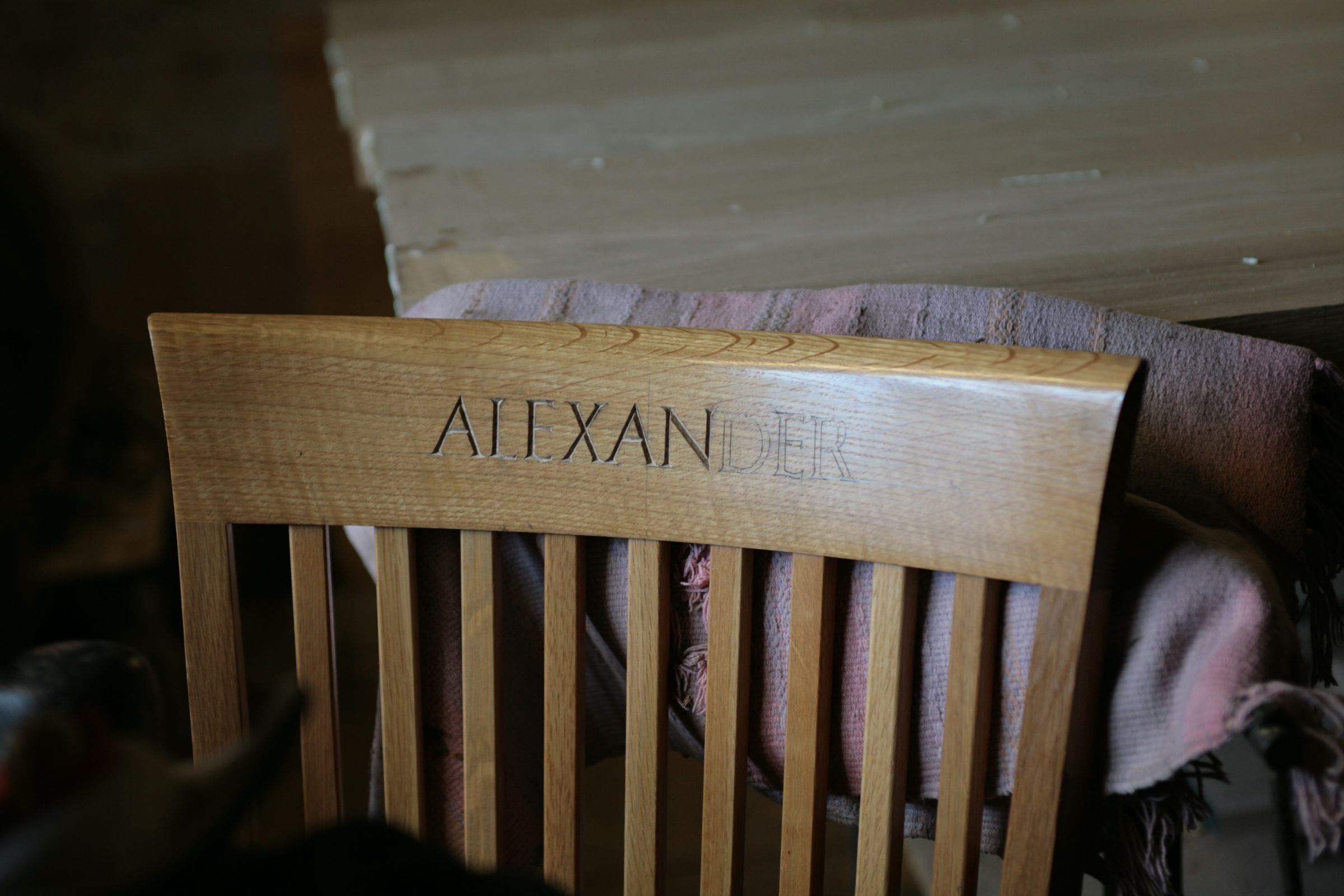 Oak chair back rail hand-carved with the name Alexander