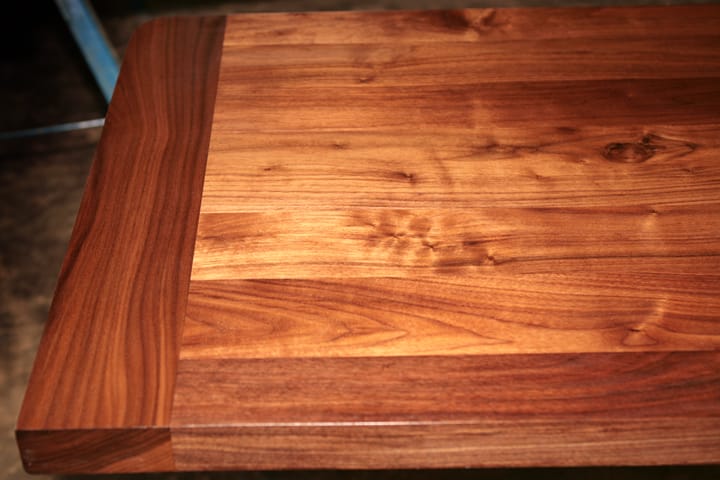 Oiled walnut table top with breadboard end showing rich figured grain