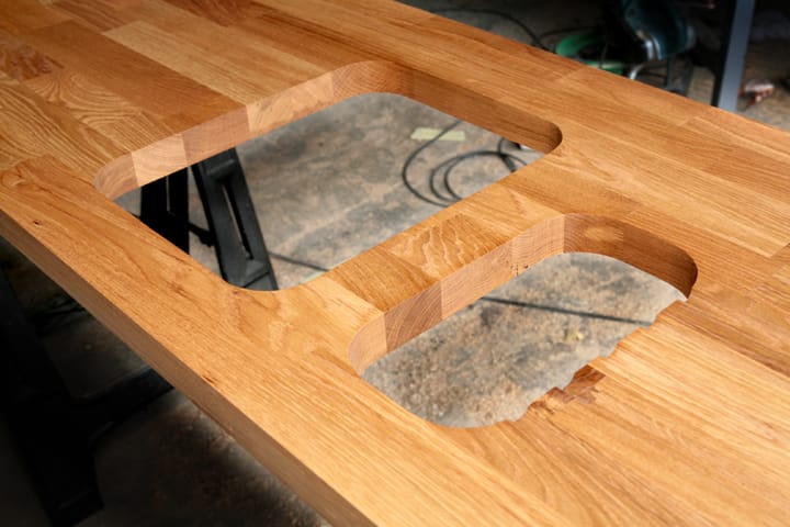 Oak worktop with routed cut-outs for a double Belfast sink in the workshop