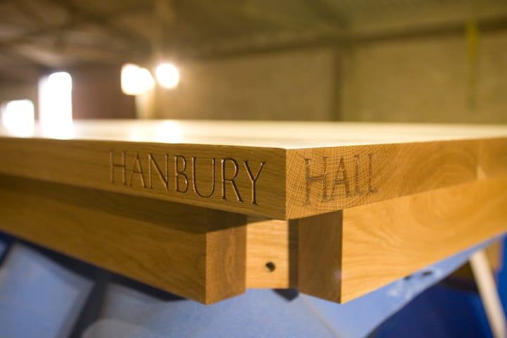Oak table edge hand-carved with the words Hanbury Hall