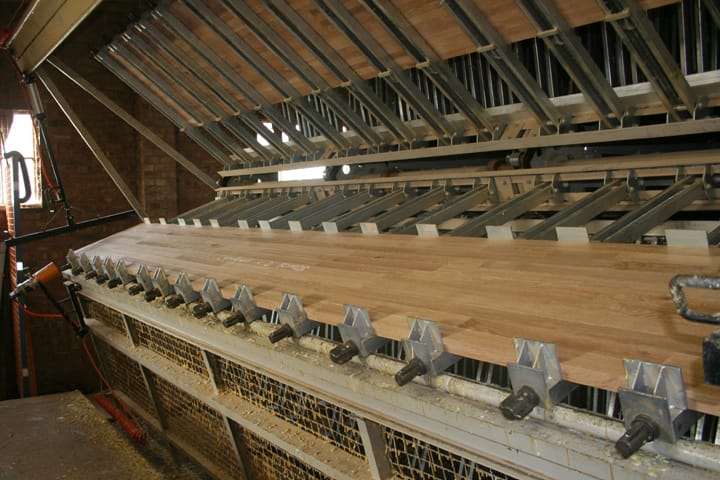 Oak worktop staves clamped in a large press in the Norfolk workshop