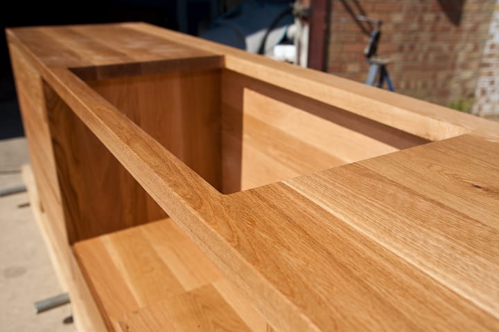 Detail of jointed oak cabinet top with recessed opening awaiting fitting