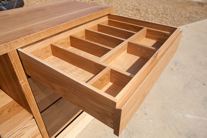 Oak cutlery drawer with bespoke compartment dividers pulled open