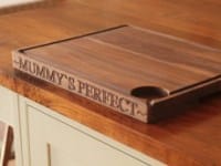 Walnut carving board engraved Mummy's Perfect on a kitchen worktop