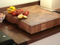 Walnut end grain chopping block with tomatoes and peppers on a worktop