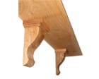 Underside of a wooden shelf supported by two carved corbels