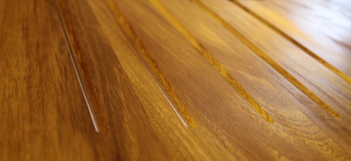Golden iroko worktop with carved draining grooves in close-up