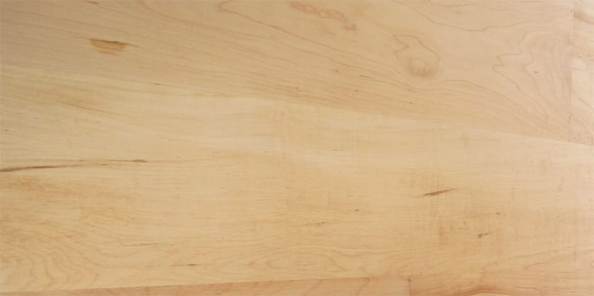 Pale creamy grain of a maple worktop in close-up