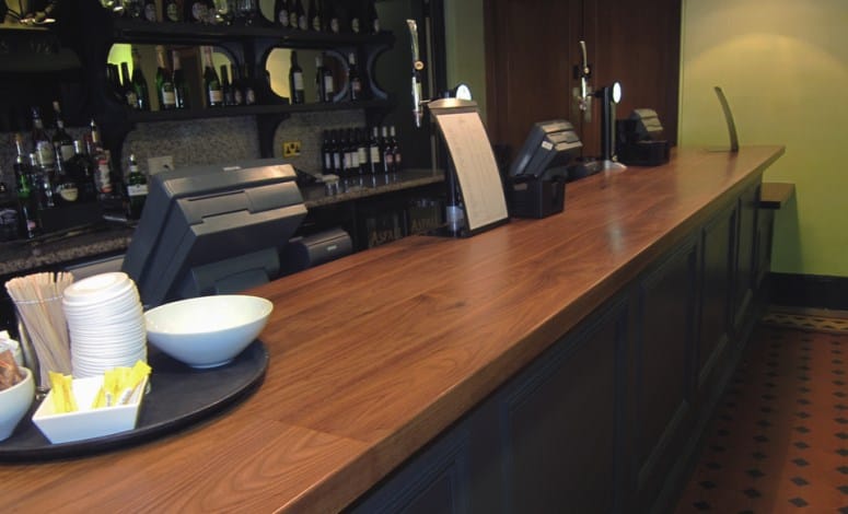 Long walnut bar top at the Royal Albert Hall with tills and beer taps