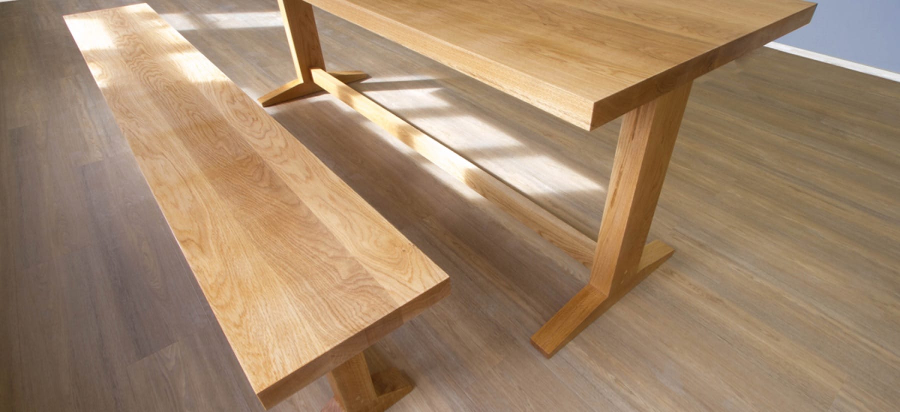 Nano-coated oak dining table and matching bench on a wooden floor