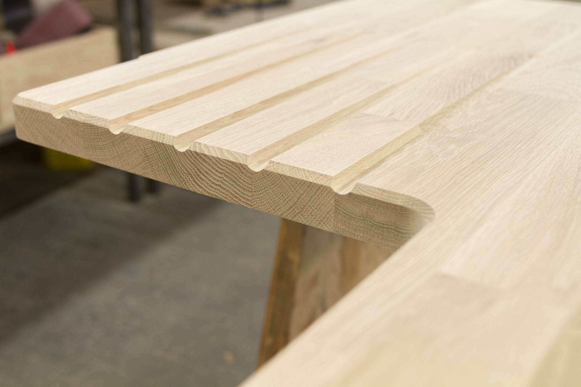 Precision-cut drainage grooves on an unoiled solid oak worktop