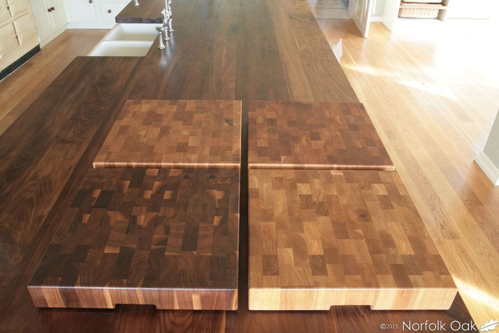 Four end grain chopping boards displayed on a walnut worktop island