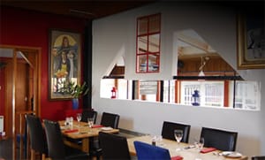 Dining tables and artwork inside the Crannog restaurant