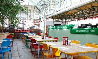 Colourful cafe seating and wooden tables at CANTEEN Covent Garden