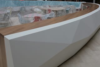 Curved white servery counter with wooden top at Marks & Spencer