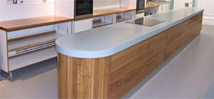 Curved wood-fronted island units at Edinburgh New Town Cookery School