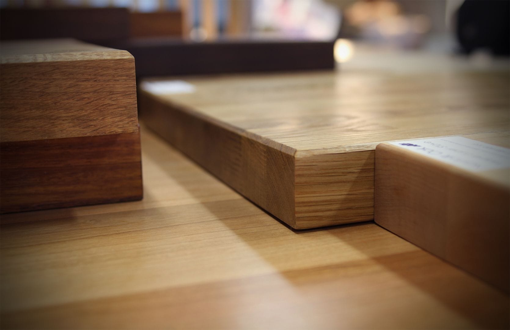 Close-up of edge profiles on wooden worktop samples in the showroom