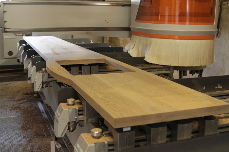 CNC machine cutting a shaped oak worktop with sink cutout