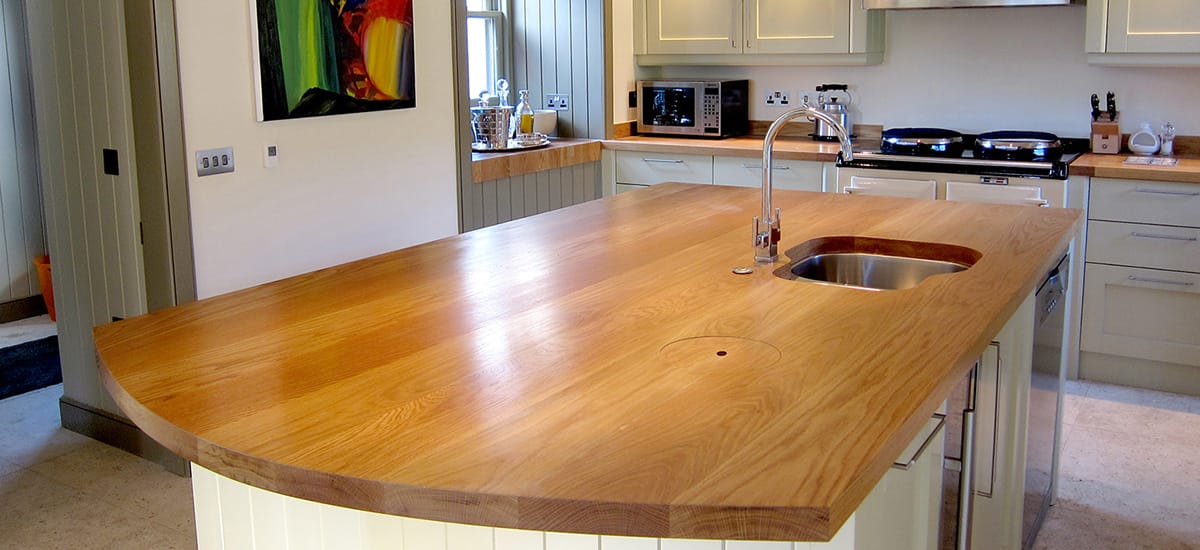 Curved oak island worktop with sink and tap, made to a bespoke CAD design