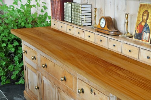 Golden iroko worktop on a pine dresser with books and a mantel clock