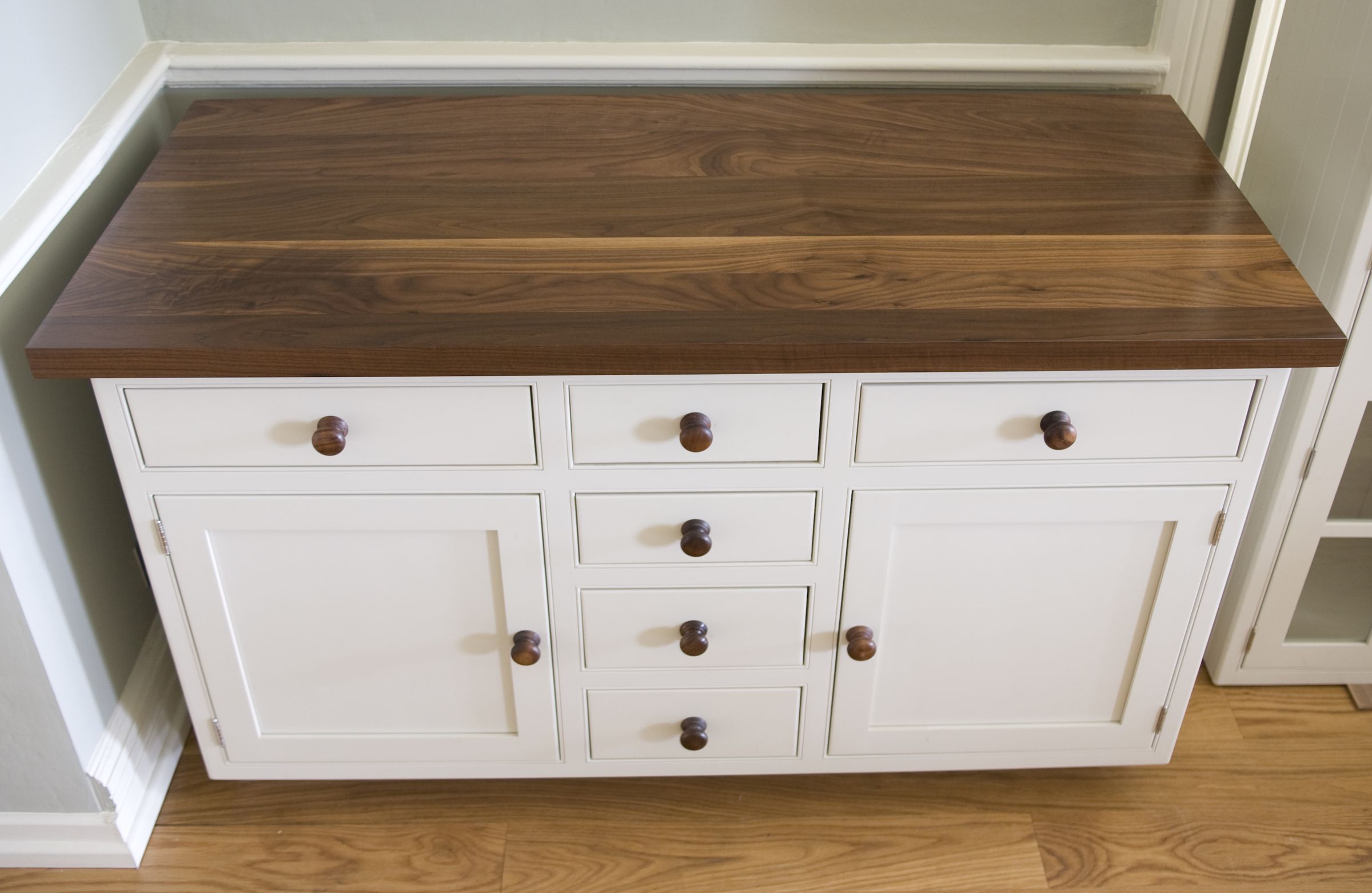 Cream painted dresser base with walnut worktop and turned wooden knobs