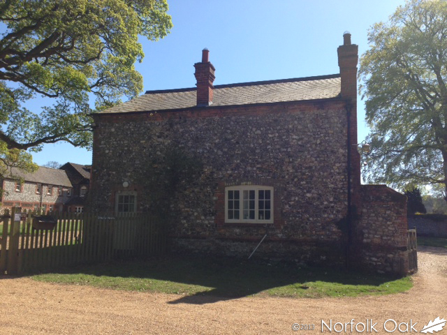 Flint and brick Norfolk Oak office building at Anmer Hall under a blue sky