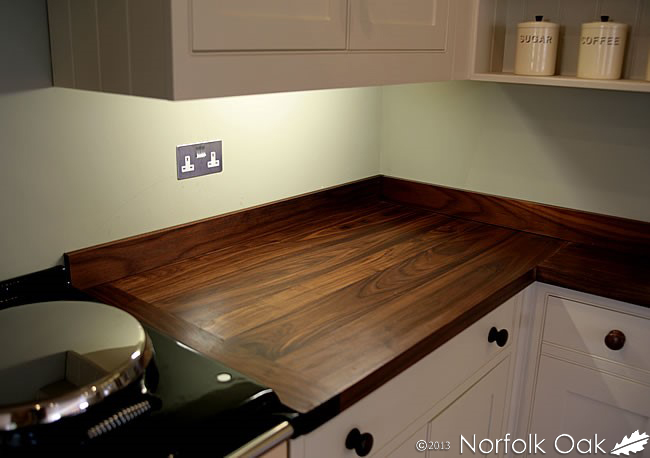 Black American walnut worktop corner with matching upstands in a cream kitchen