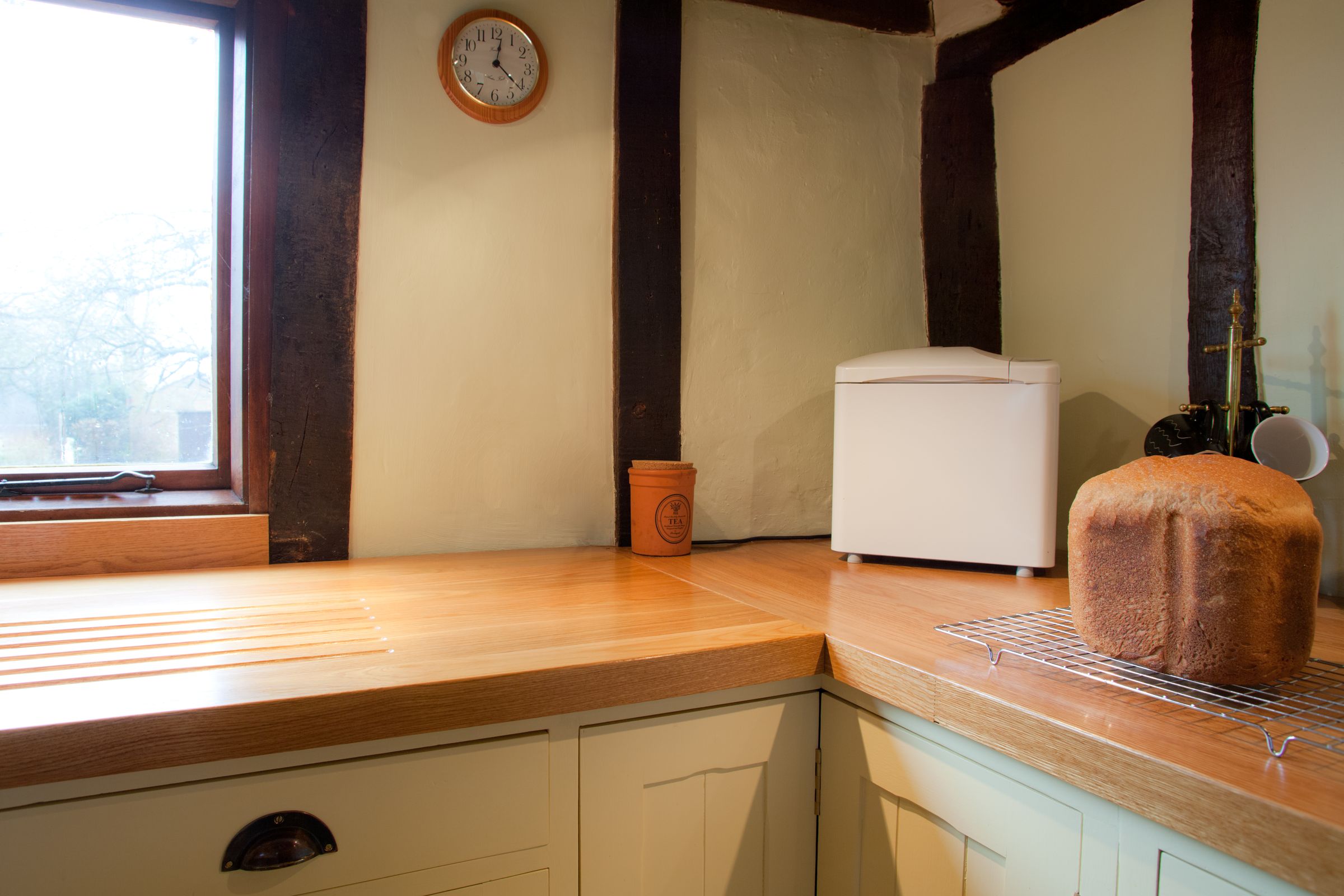 oak worktop Oak worktops with carved draining grooves in a beamed cottage kitchen