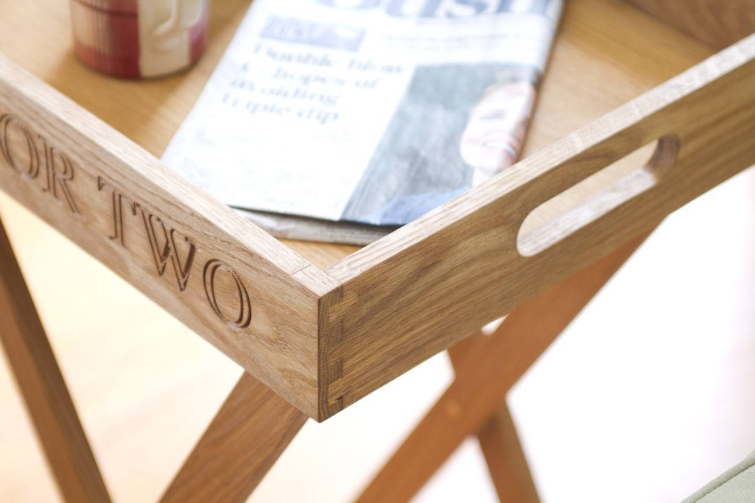 butlers tray with tea Corner of an engraved oak butler's tray holding a newspaper, showing dovetail joints