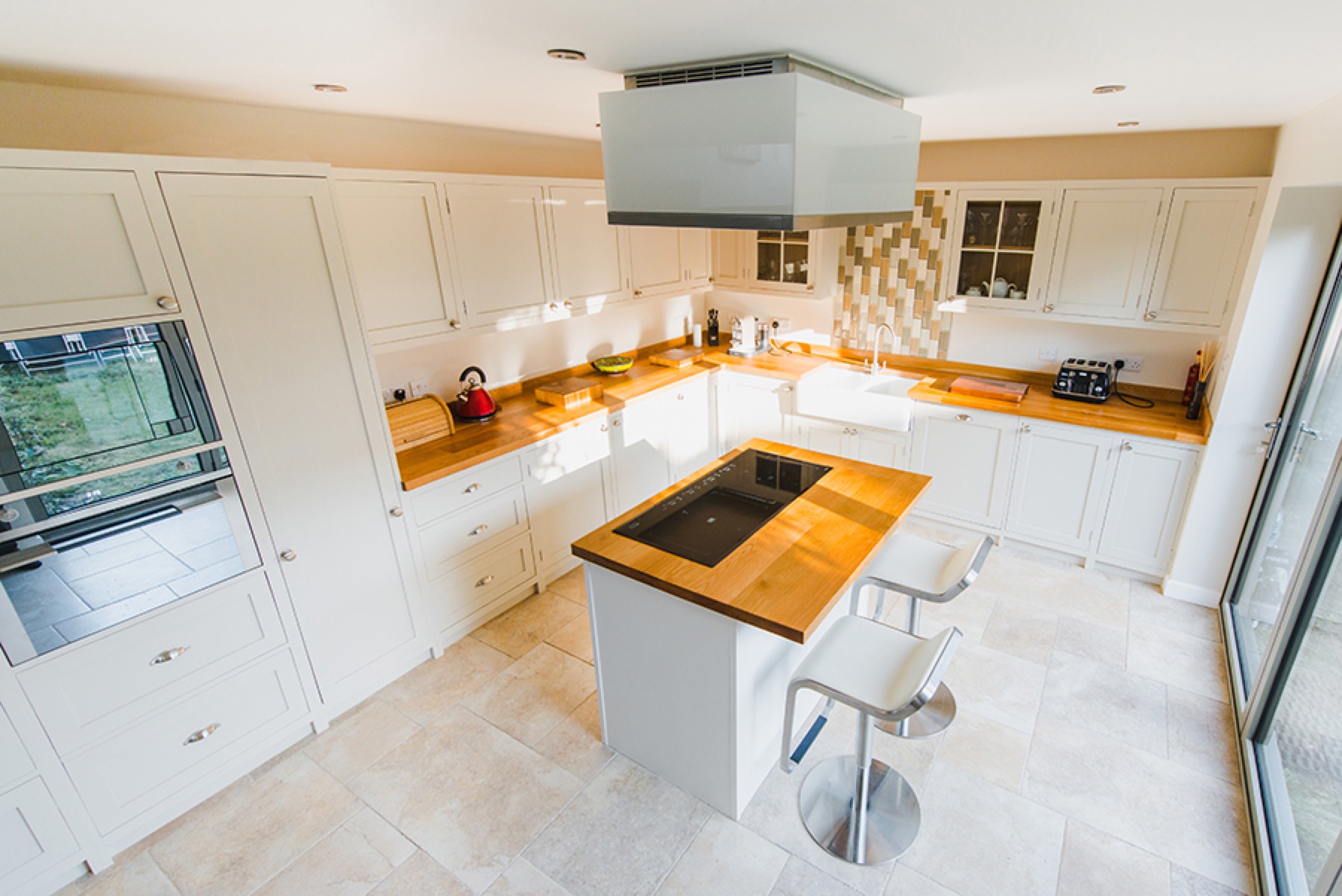 bespoke oak worktops white kitchen White shaker kitchen with oak worktops, island breakfast bar and inset hob