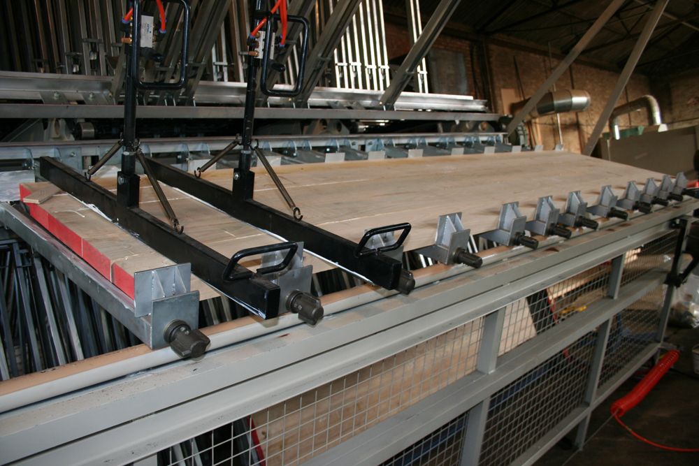 Glued worktop staves held under pressure in a clamping press at the Norfolk Oak workshop