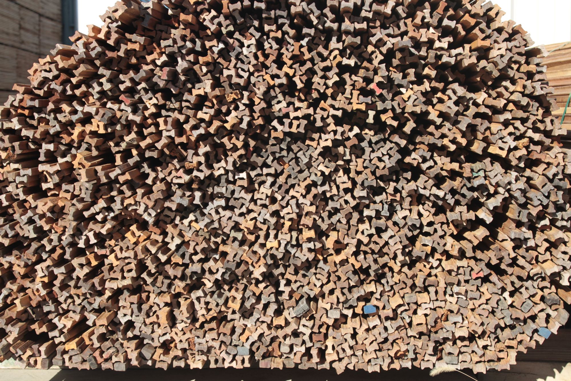 Large stack of rough sawn timber lengths viewed end on