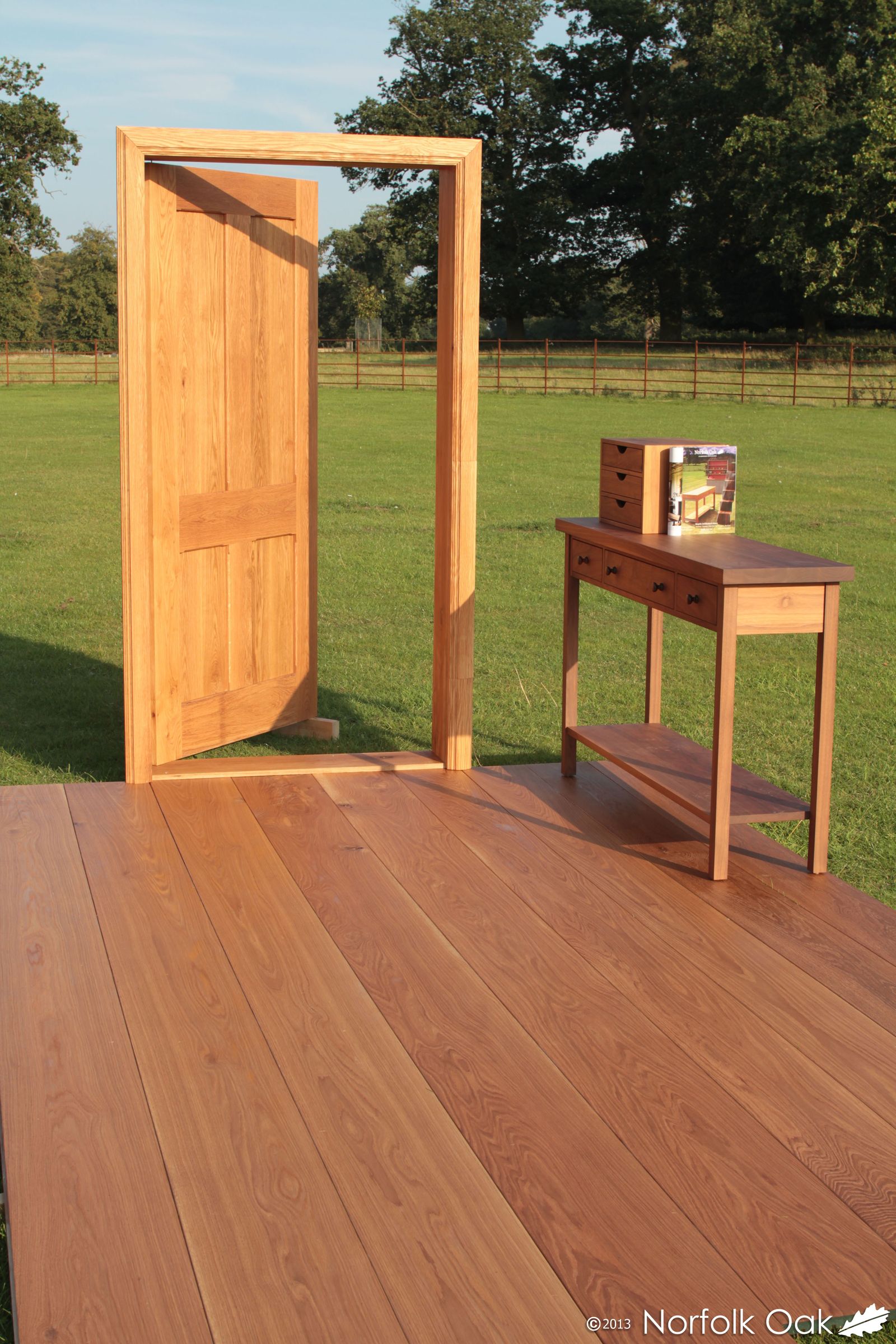Oak door, console table and oak flooring staged outdoors on a sunny paddock